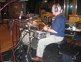 One of Frampton's friends putting the drums down. 